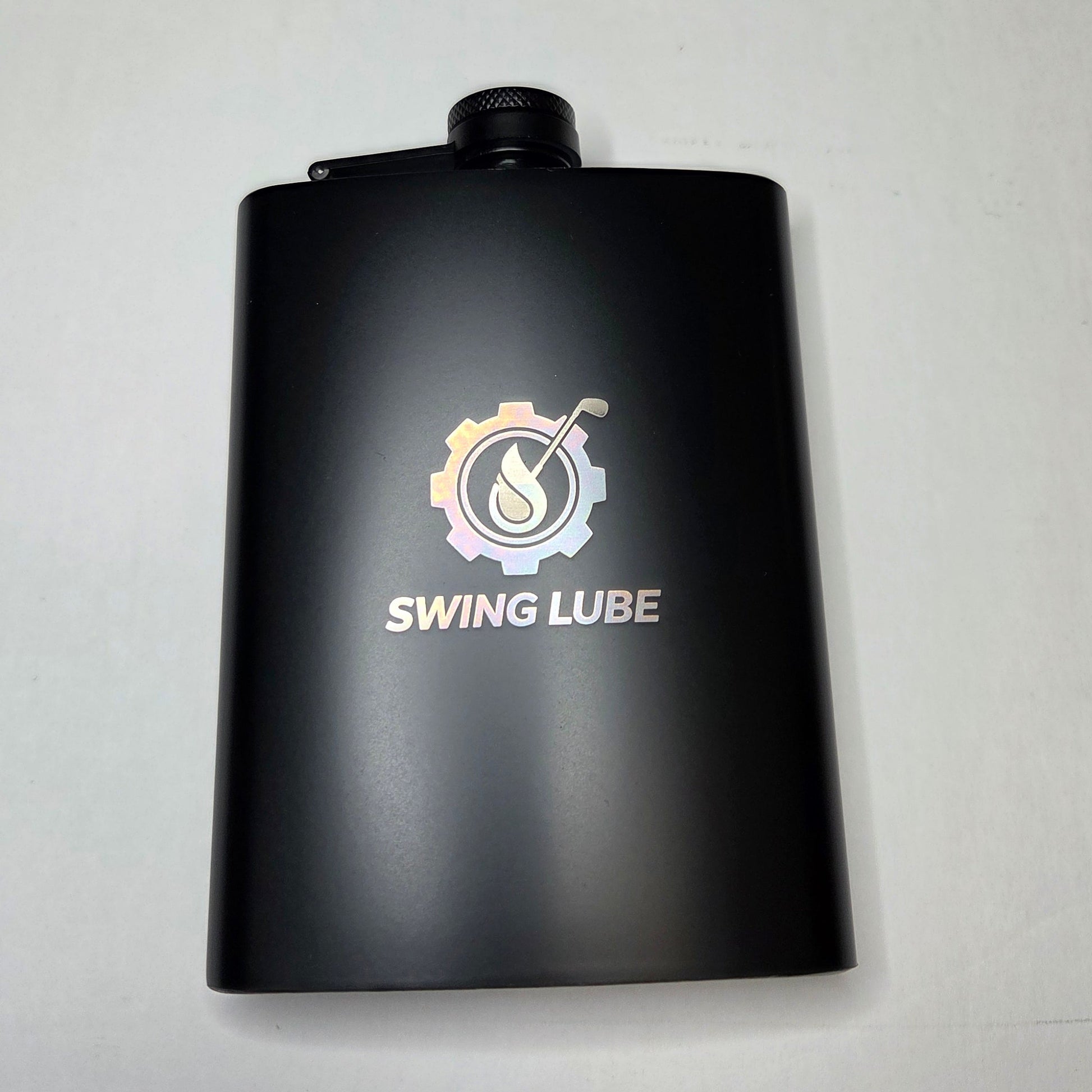 Black bottle of Swing Lube on a light gray background