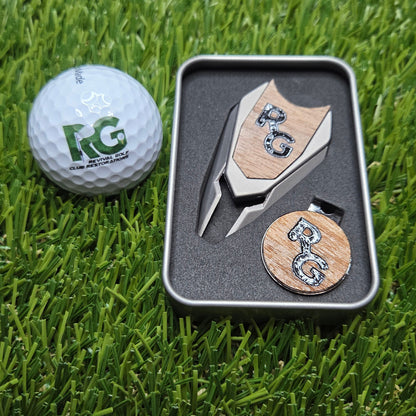 Golf ball with a putter and two wooden markers on grass
